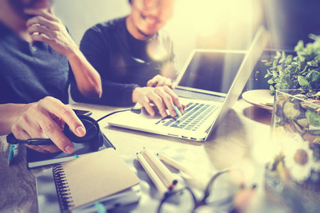 Co worker using VOIP headset with digital tablet computer docking smart keyboard, concept communication, it support, call center and customer service help desk,vintage film effectの写真素材