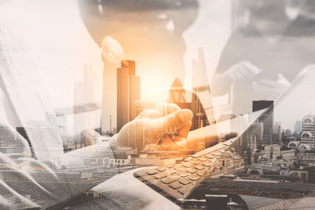 Double exposure,business documents on office table with smart phone and laptop computer and graph financial with social network diagram and three colleagues discussing data の写真素材