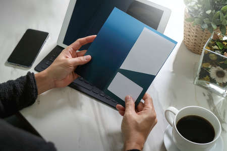 Businessperson Hands holding New Gift Card or Credit card,digital tablet computer dock keyboard,smart phone on marble desk,filter effectの写真素材