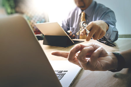 Medical technology network team meeting concept. Doctor hand working smart phone modern digital tablet laptop computer graphics chart interface.eyeglass, sun flare effect photoの写真素材