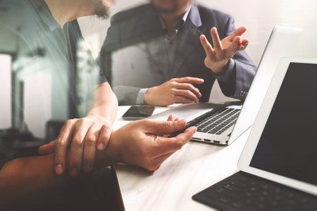 Business team meeting. Photo professional investor working new start up project. Finance task.Digital tablet docking keyboard laptop computer smart phone using, filter film effectの写真素材