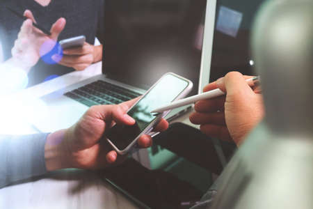 Business team meeting present. Photo professional investor working with new startup project. Finance managers meeting.Digital tablet laptop computer design smart phone using.Sun flare effectの写真素材