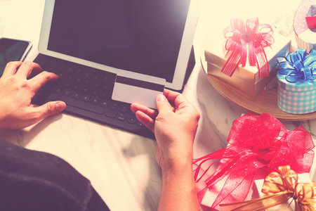 Gift giving Creative Hand with credit card and hand with gift. Gift delivery, surprise,tablet...