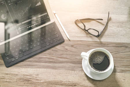 Coffee cup and Digital table dock smart keyboard,eyeglasses,stylus pen on wooden table,filter effect,icons screeenの写真素材