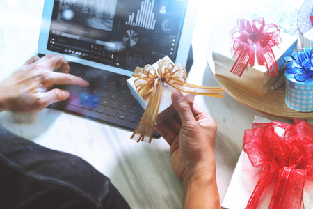 Gift giving Creative Hand typing and hand with gift. Gift delivery, surprise,tablet computer docking...