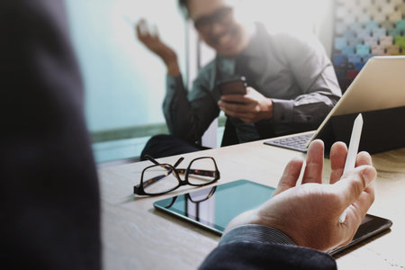 Business team meeting present. professional investor working new startup project. Finance managers meeting.Digital tablet keyboard docking screen computer design smart phone using, reflected viewの写真素材