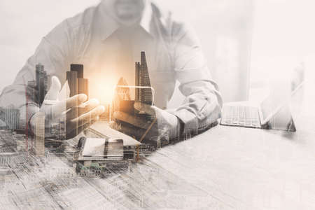 Double Exposure,businessman working with new start up project.using smart phone digital tablet docking smart keyboard on wooden desk,sun effectの写真素材
