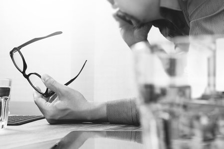 Businessman hand using mobile payments online shopping,omni channel,laptop computer on wooden...