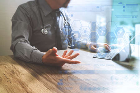 Medical technology concept. Doctor hand working with modern digital tablet dock screen computer with medical chart interface, Sun flare effect photoの写真素材