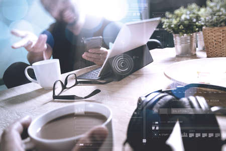 co working creative designers working at office and holding a cup of coffee,working on smart phone and digital tablet computer docking on smart keyboard,filter film effect                               の写真素材