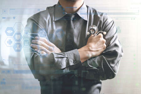 smart medical doctor across his arms, touch screen computer,stethoscope ,front view,filter effect,business strategy icons interfaceの写真素材