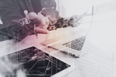 Double exposure of Medical technology concept. Doctor hand working with modern digital tablet and laptop computer with London architecture,buildingの写真素材