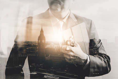 Double exposure of smart medical doctor holding digital tablet computer,stethoscope with London city,Bigben,front view,filter effectの写真素材