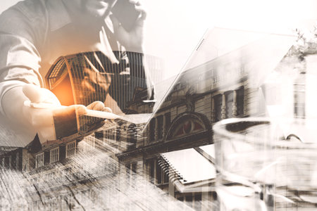 Double exposure of success businessman using stylus pen,digital tablet docking smart keyboard  with...