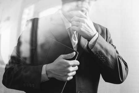 success businessman holding digital tablet computer,front view,filter effect,black whiteの写真素材