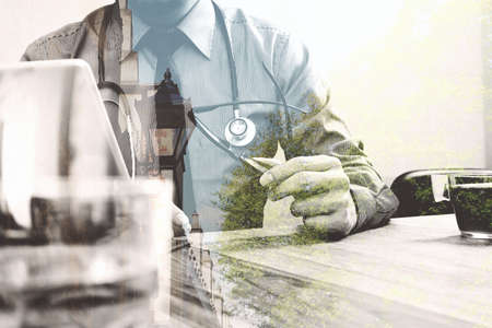 Double exposure of smart medical doctor working with digital tablet computer,stethoscope and London city,eyeglass,side view,filter effectの写真素材