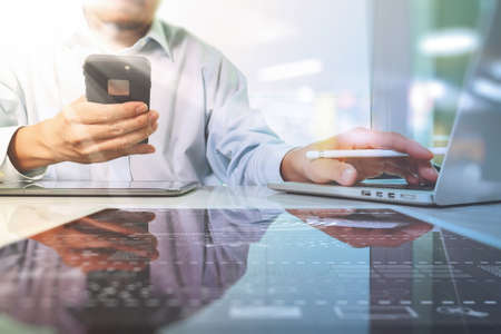 Team work concept,businessman hand attending video conference in modern office.Digital tablet laptop computer design smart phone using. Sun effectsの写真素材