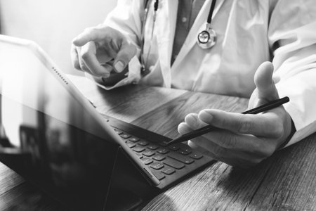 smart medical doctor hand working with smart phone,digital tablet computer,stethoscope eyeglass,on...