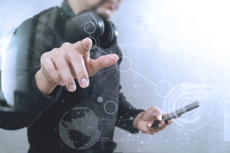Businessman hand pressing an imaginary button,holding smart phone,digital screen graphic virtual...
