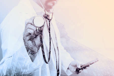 Double exposure of Medical technology concept. Doctor hand working with modern smart phone with medical chart interface,multi channel connection,London buildingsの写真素材