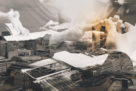 Double exposure of two colleague web designer discussing data and digital tablet and computer laptop...