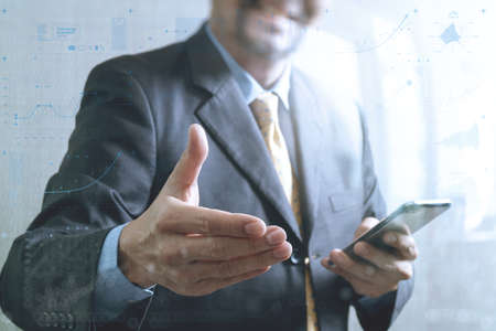 success businessman open his hand,smart phone,front view,filter effect,business strategy icons interfaceの写真素材
