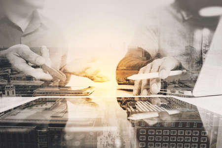 Double exposure of Business team meeting present. Photo professional investor working with new startup project. Digital tablet laptop computer with London architecture,buildingの写真素材