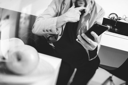 hipster hand using smart phone for mobile payments online business,sitting on sofa in living...