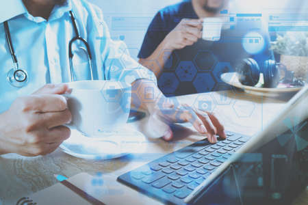 Medical doctor team taking coffee break.using digital tablet docking smart keyboard and smart phone on marble desk.listen music,filter film effectの写真素材