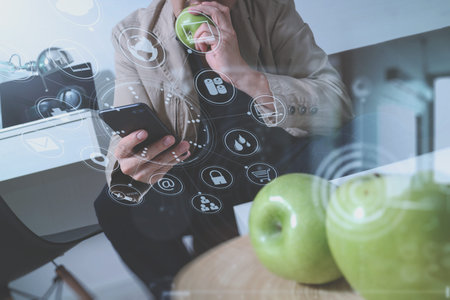 hipster hand using smart phone for mobile payments online business,sitting on sofa in living...