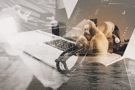 Double exposure of Medical technology network team meeting concept. Doctor hand working smart phone modern digital tablet laptop computer with London architecture,buildingの写真素材