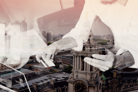 double exposure of hipster hand using smart phone and laptop compter,holding cradit card payments online business,sitting on sofa in living room,green apples in wooden tray,London cityの写真素材