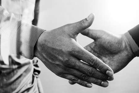 Business partnership meeting concept.photo businessmans handshake. Successful businessmen handshaking after perfect deal.close up,black and whiteの写真素材