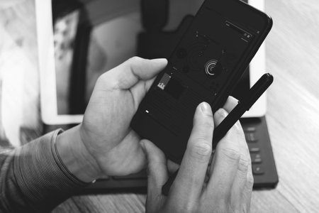 close up of hand using mobile payments online shopping,omni channel,in modern office wooden...