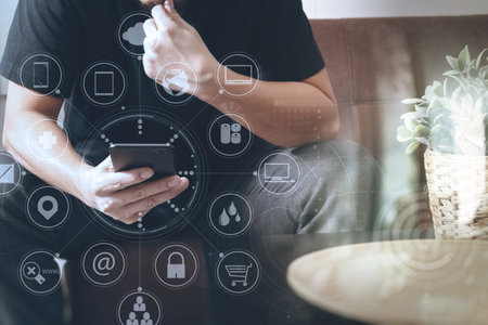 designer man hand using smart phon for mobile payments online shopping,omni channel,sitting on sofa...