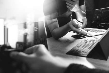 StartUp Programming Team. Website designer working digital tablet dock keyboard and computer laptop with smart phone and compact server on mable desk,black whiteの写真素材