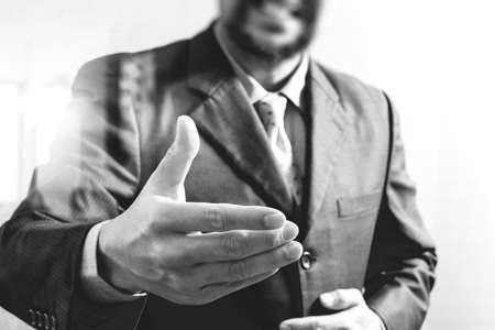 businessman with an open hand ready to seal business investor project deal,front view,black and whiteの写真素材