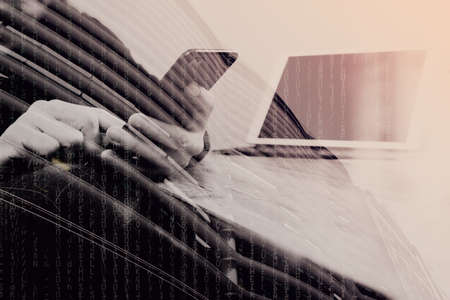 double exposure of businessman hand using smart phone,mobile payments online shopping,omni channel,digital tablet docking keyboard computer in modern office on wooden desk,London architecture cityの写真素材