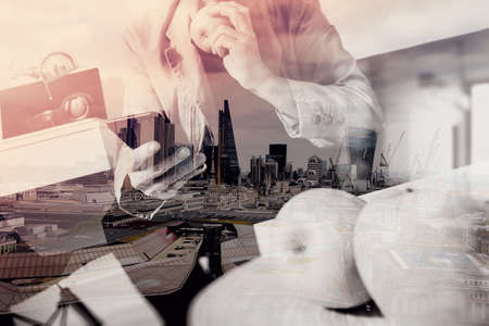 double exposure of hipster hand using smart phone for mobile payments online business,sitting on sofa in living room,holding green apple in wooden tray,London architecture cityの写真素材