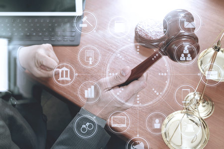 justice and law concept.Male judge in a courtroom with the gavel,working with smart phone,digital...