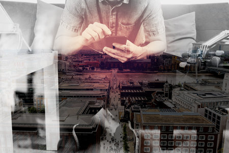 double exposure of hipster hand using smart phone,digital tablet docking keyboard,holding cradit...