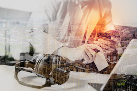 double exposure of hipster hand using smart phone,digital tablet docking keyboard,holding credit...