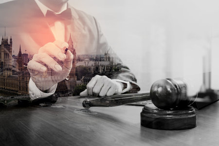 double exposure of justice and law concept.Male judge in a courtroom with the gavel,working with...