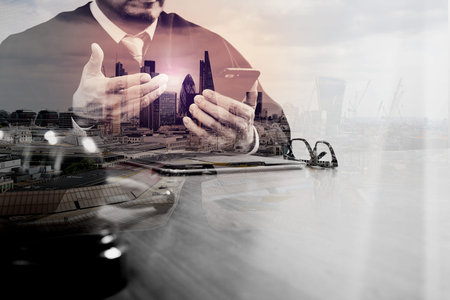 double exposure of justice and law concept.Male judge in a courtroom with the gavel,working with...
