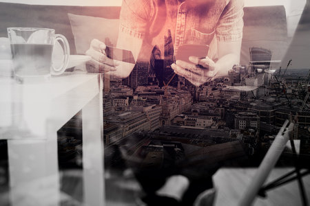 double exposure of hipster hand using smart phone,digital tablet docking keyboard,holding credit...