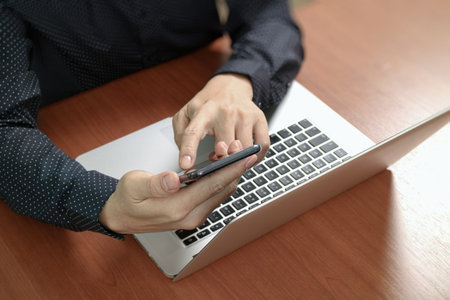 top view,business man hand using smart phone,laptop, online banking payment communication network...