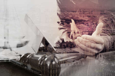 Male lawyer in office with the gavel,working with smart phone and digital tablet computer and brass scale on wood table,London city background,double exposureの写真素材