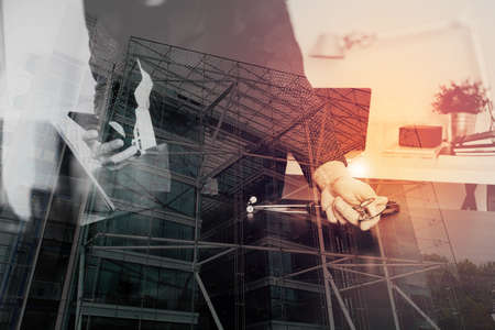 double exposure of Medical technology concept. Doctor hand working with smart phone,laptop,modern digital tablet dock screen computer in modern clinic office room,London architecture cityの写真素材