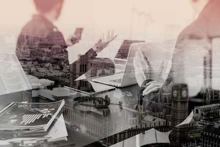 co working meeting,two businessman using VOIP headset with latop computer on desk in modern office as call center and customer service help desk concept with virtual interface graphic icons network diagramの写真素材