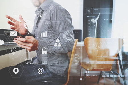 businessman working with smart phone and digital tablet and laptop computer in modern office with...